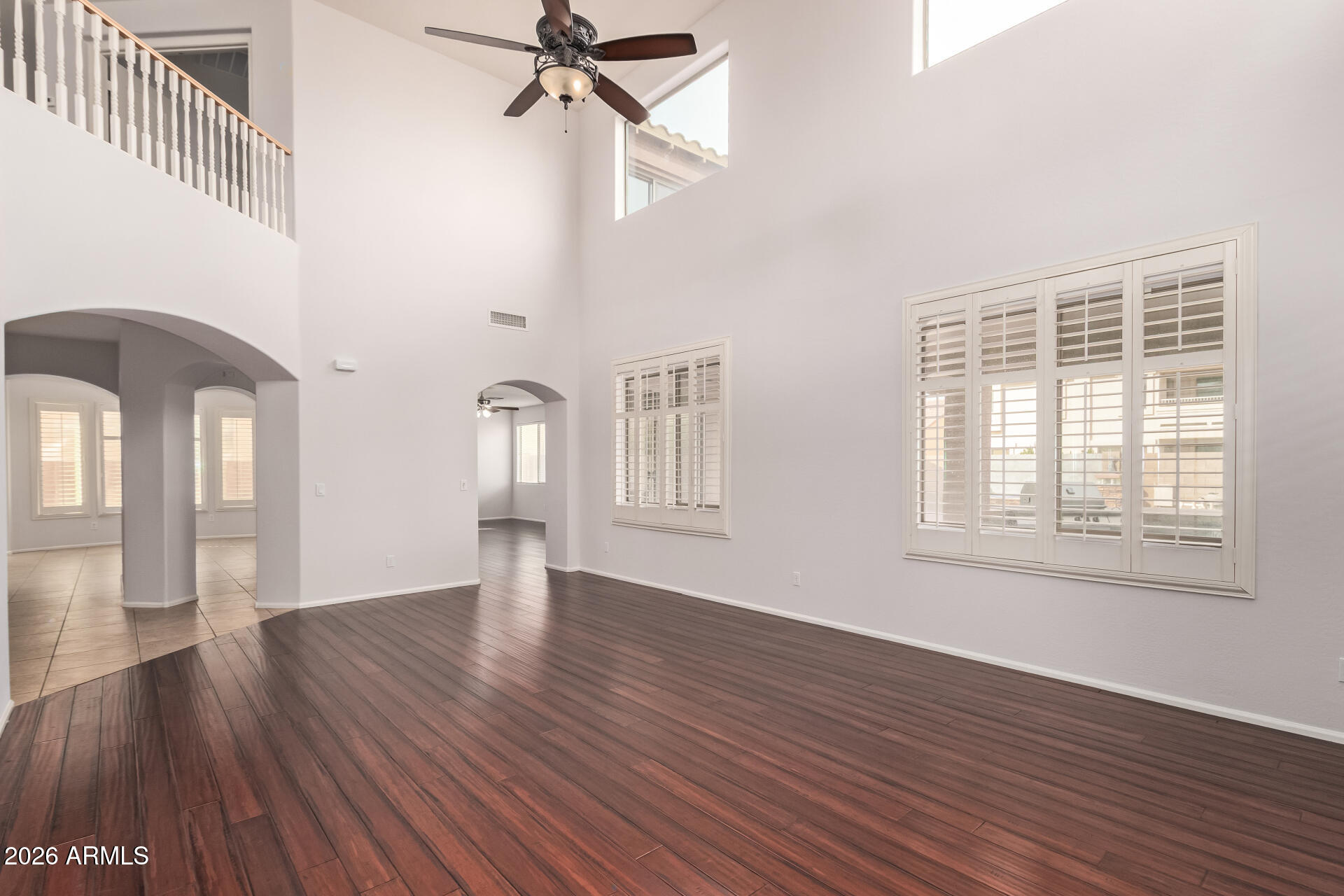 41106 West Coltin Way Maricopa, AZ 85138 - Photo 7 of 51 a view of an empty room with wooden floor and a window