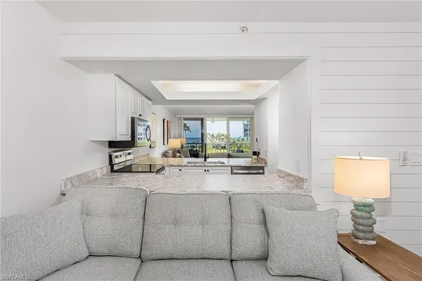 a living room with furniture and a lamp