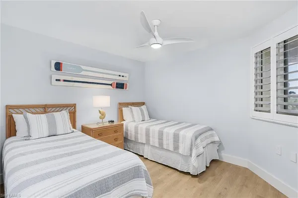 a bedroom with two beds and a window