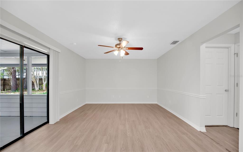 1050 Dishman Loop Oviedo, FL 32765 - Photo 12 of 32 wooden floor in an empty room with a window