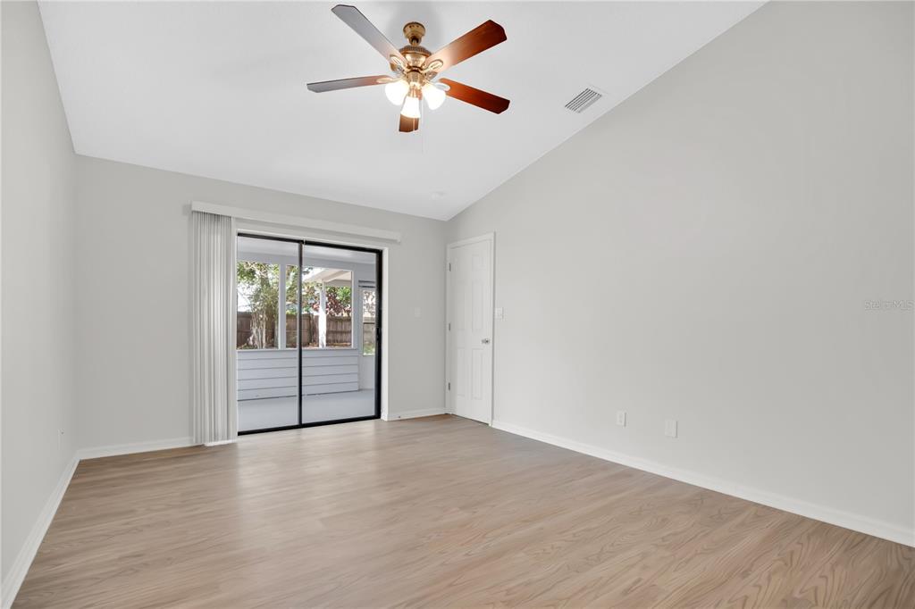 1050 Dishman Loop Oviedo, FL 32765 - Photo 14 of 32 an empty room with wooden floor and windows
