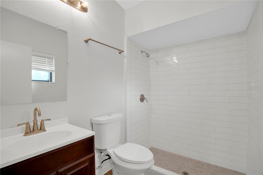 1050 Dishman Loop Oviedo, FL 32765 - Photo 16 of 32 a bathroom with a sink a toilet and a mirror