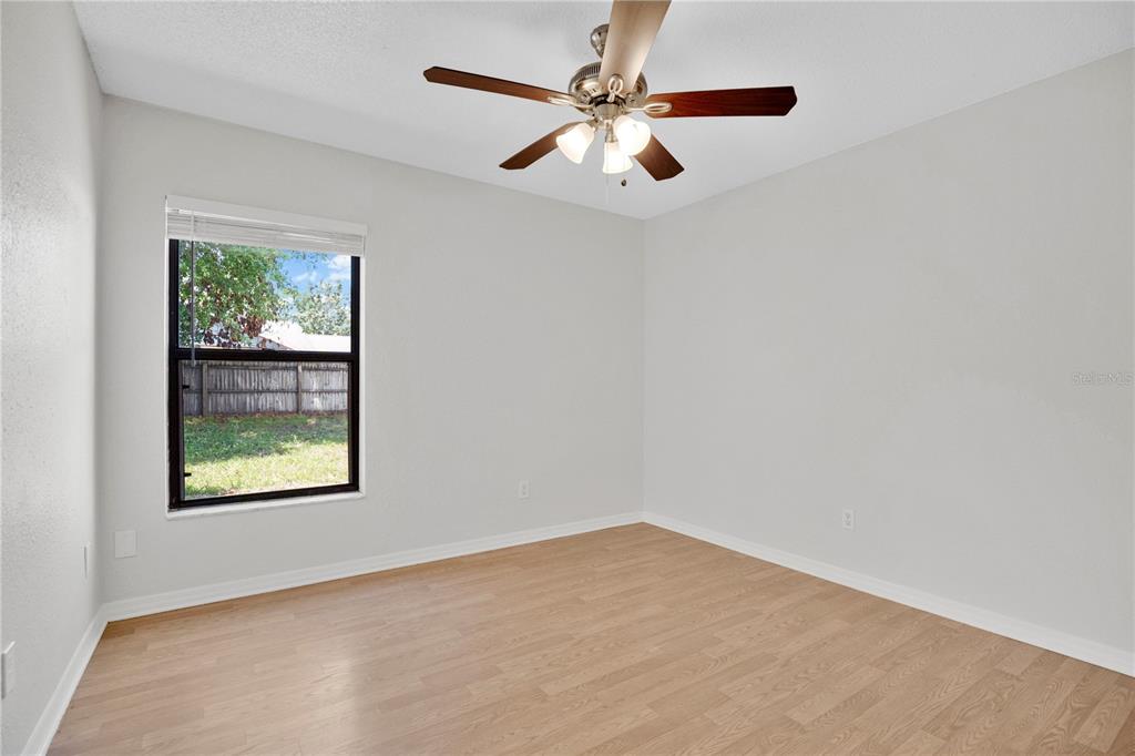 1050 Dishman Loop Oviedo, FL 32765 - Photo 17 of 32 an empty room with a window and a ceiling fan