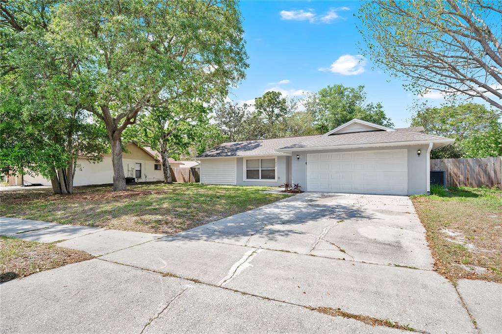 1050 Dishman Loop Oviedo, FL 32765 - Photo 2 of 32 a view of a house with a yard and large tree