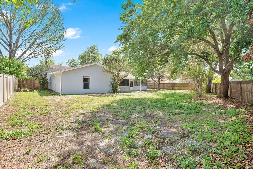1050 Dishman Loop Oviedo, FL 32765 - Photo 24 of 32 a house with huge green field in front of it
