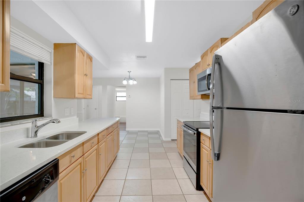 1050 Dishman Loop Oviedo, FL 32765 - Photo 8 of 32 a kitchen with granite countertop a sink and refrigerator