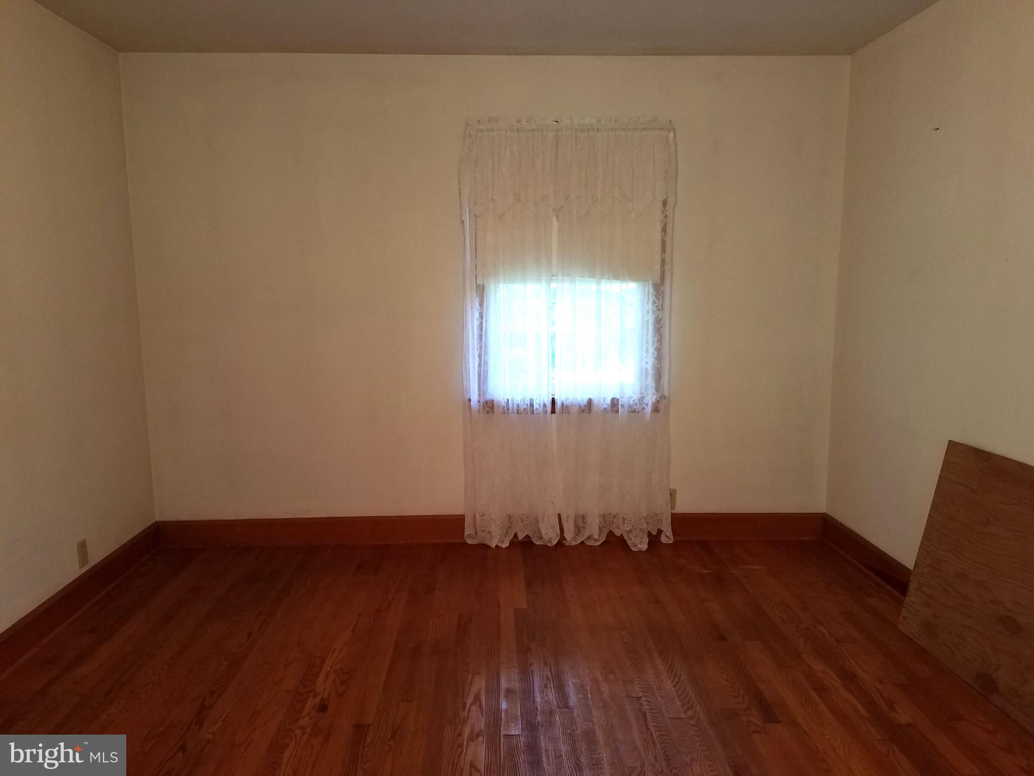 4349 Middlepoint Road Myersville, MD 21773 - Photo 8 of 27 an empty room with wooden floor and windows