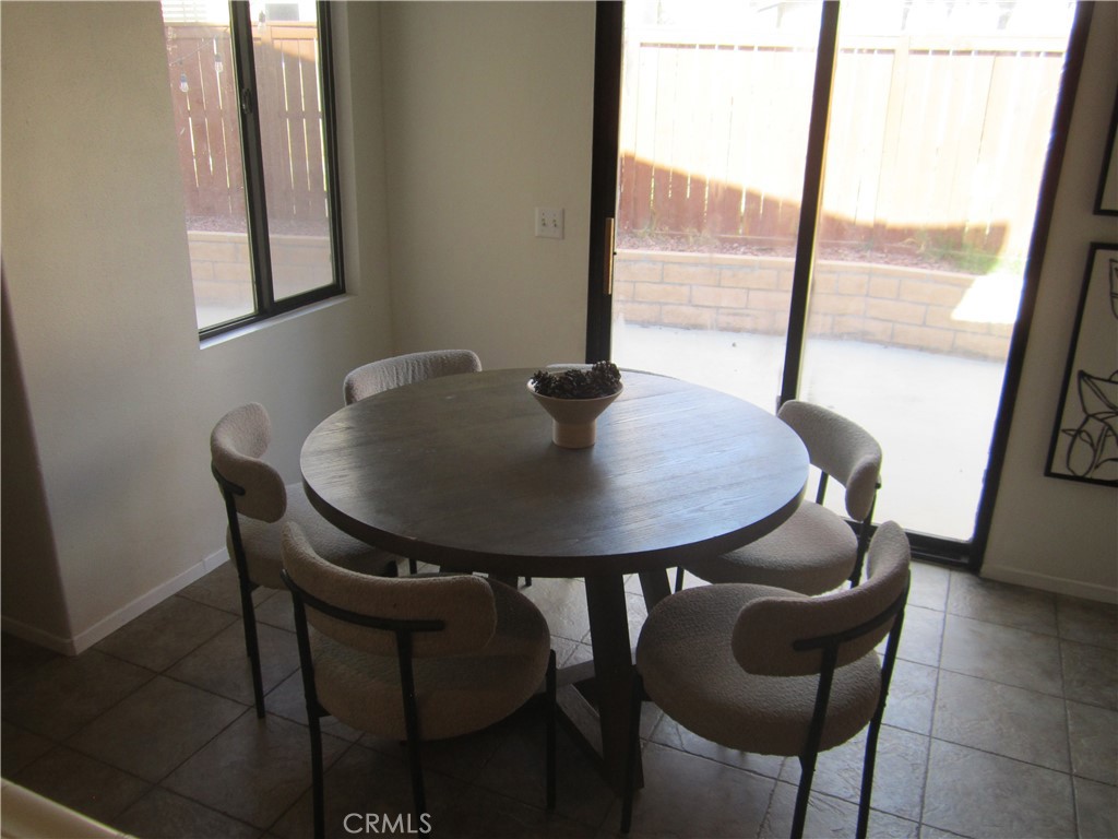3908 Manquelo Court Perris, CA 92571 - Photo 12 of 36 a view of a dining room with furniture and wooden floor