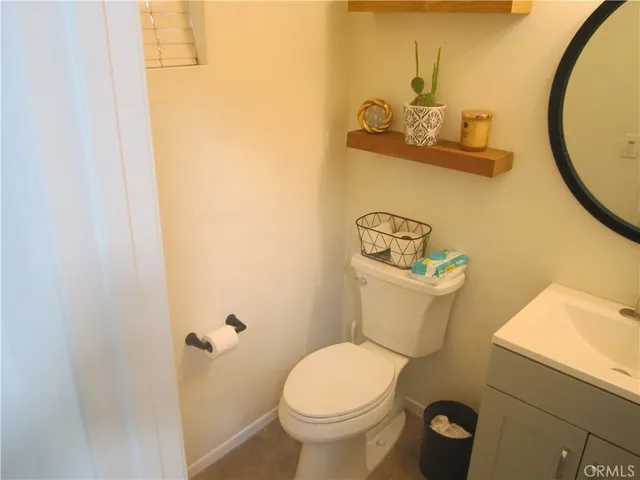 a bathroom with a toilet and a mirror