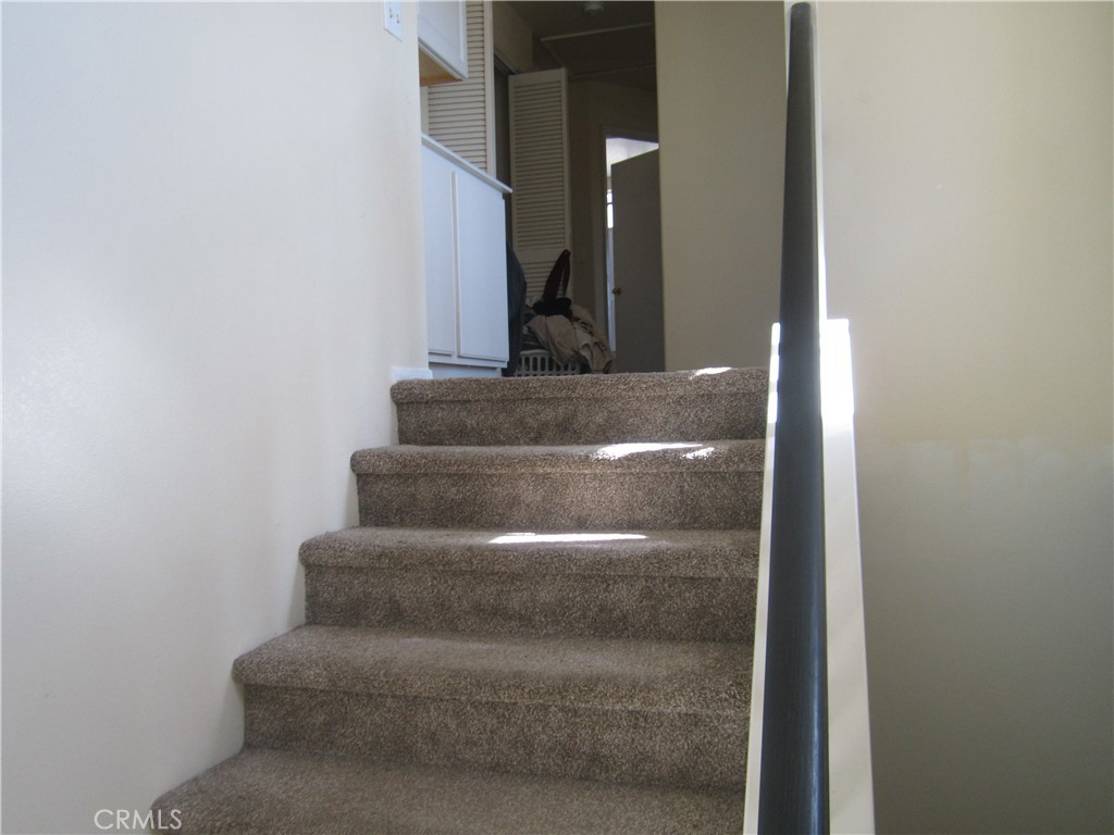 3908 Manquelo Court Perris, CA 92571 - Photo 16 of 36 a view of staircase with white walls