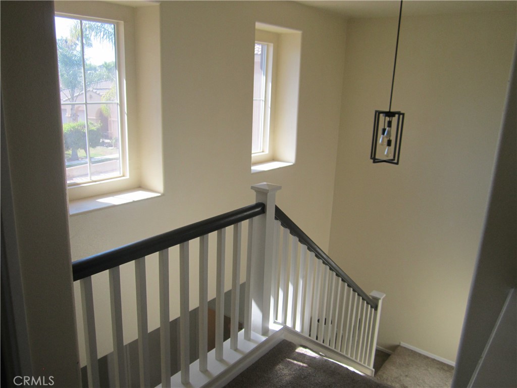 3908 Manquelo Court Perris, CA 92571 - Photo 17 of 36 a view of staircase with windows