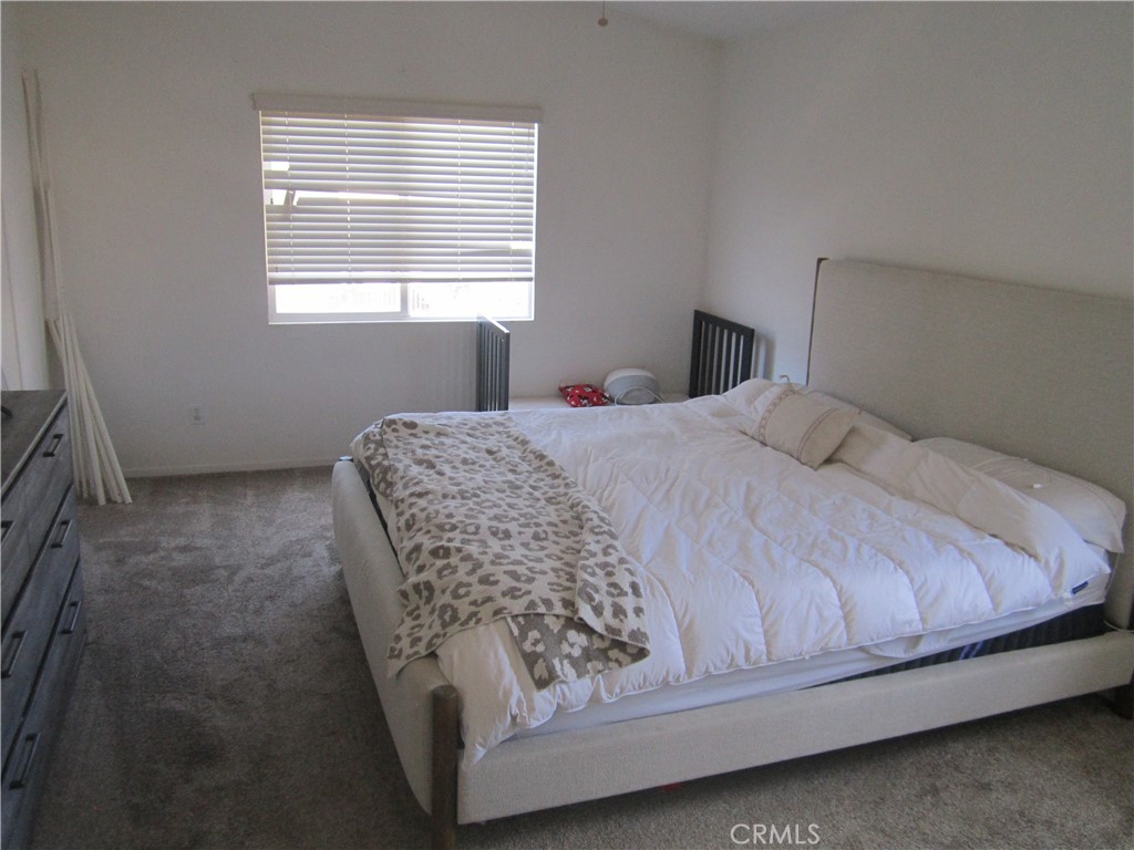 3908 Manquelo Court Perris, CA 92571 - Photo 20 of 36 a room with a bed and a window