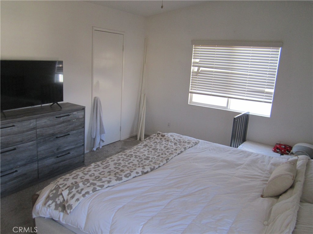 3908 Manquelo Court Perris, CA 92571 - Photo 21 of 36 a bedroom with a bed and a flat screen tv