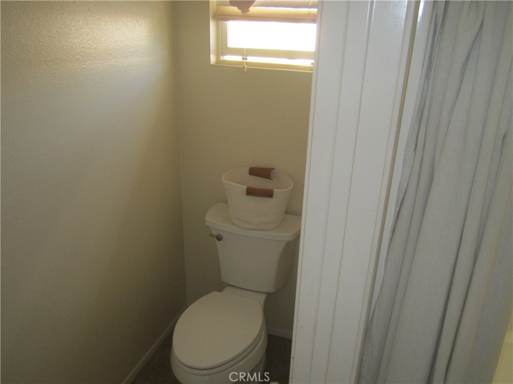 3908 Manquelo Court Perris, CA 92571 - Photo 23 of 36 a white toilet sitting next to a shower