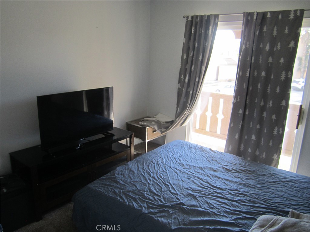 3908 Manquelo Court Perris, CA 92571 - Photo 27 of 36 a bedroom with a bed and a window