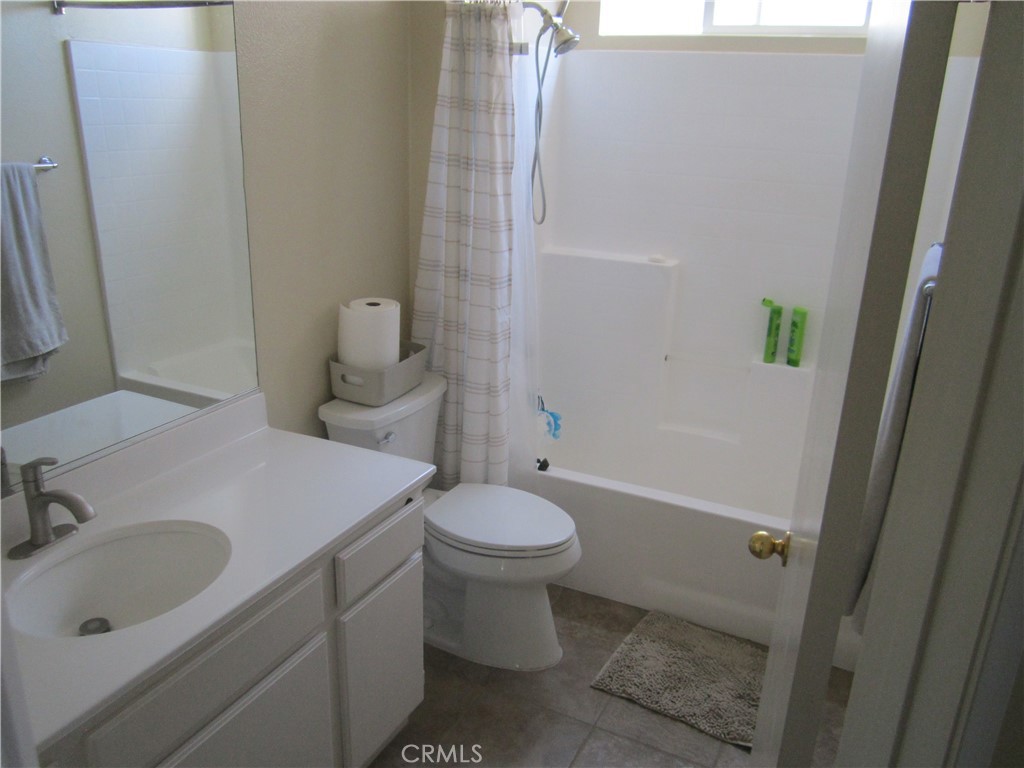 3908 Manquelo Court Perris, CA 92571 - Photo 29 of 36 a bathroom with a sink toilet and shower