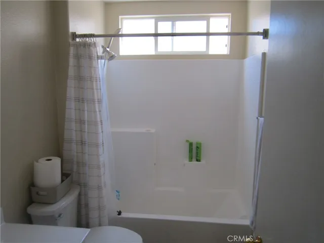 a bathroom with a toilet and shower