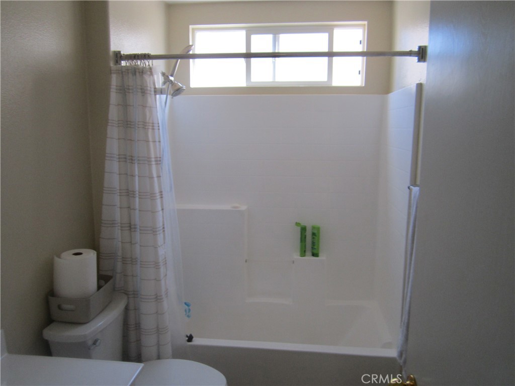 3908 Manquelo Court Perris, CA 92571 - Photo 30 of 36 a bathroom with a toilet and shower