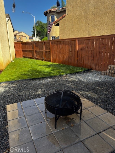 3908 Manquelo Court Perris, CA 92571 - Photo 35 of 36 a view of a backyard with table and chairs