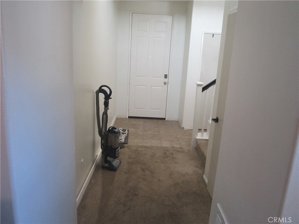 3908 Manquelo Court Perris, CA 92571 - Photo 4 of 36 a room that has a bed and a table in it