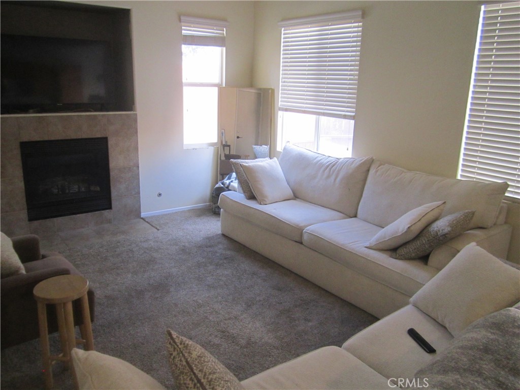 3908 Manquelo Court Perris, CA 92571 - Photo 7 of 36 a living room with furniture and a fireplace