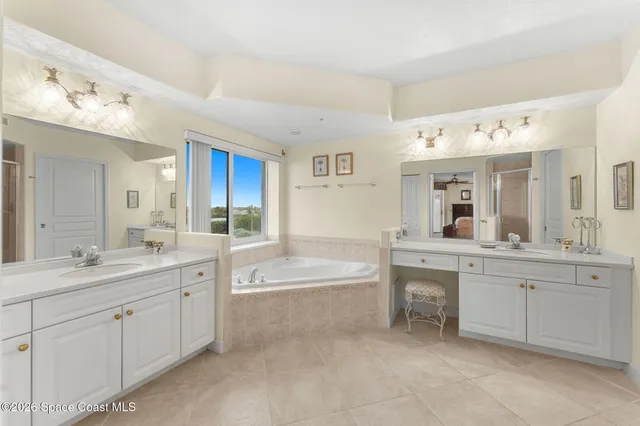 a large bathroom with a glass shower door a sink and a bathtub