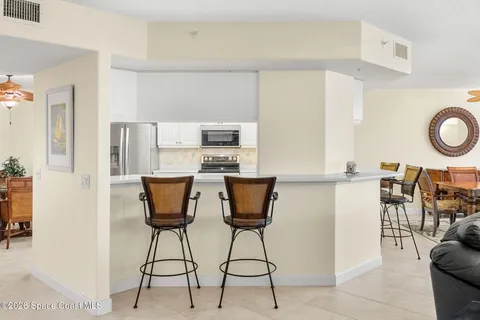 a large white kitchen with a large window