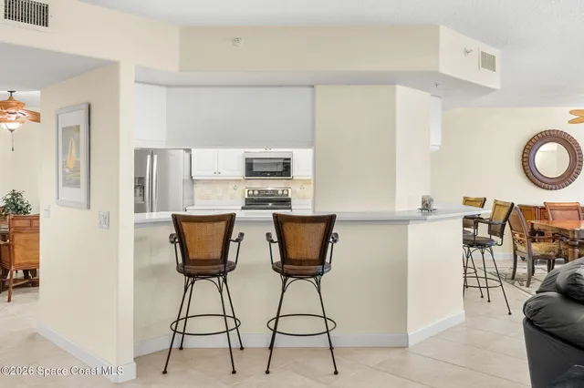 a kitchen with stainless steel appliances kitchen island granite countertop a table and chairs