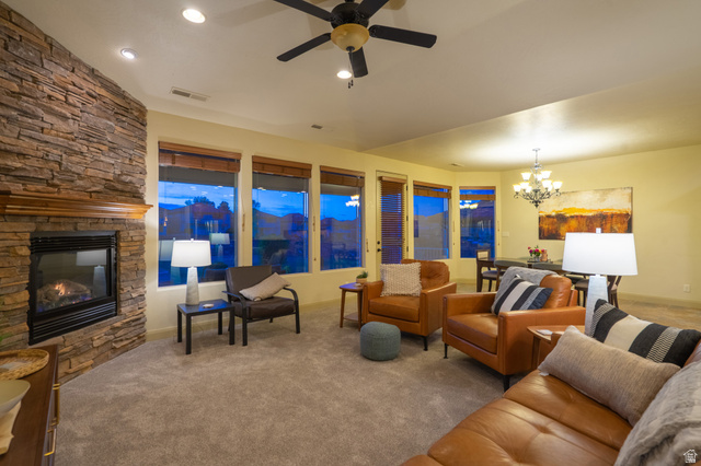 2212 Chippenham Court St. George, UT 84770 - Photo 9 of 75 Carpeted living area with suspended lighting, a ceiling fan, and a stone fireplace