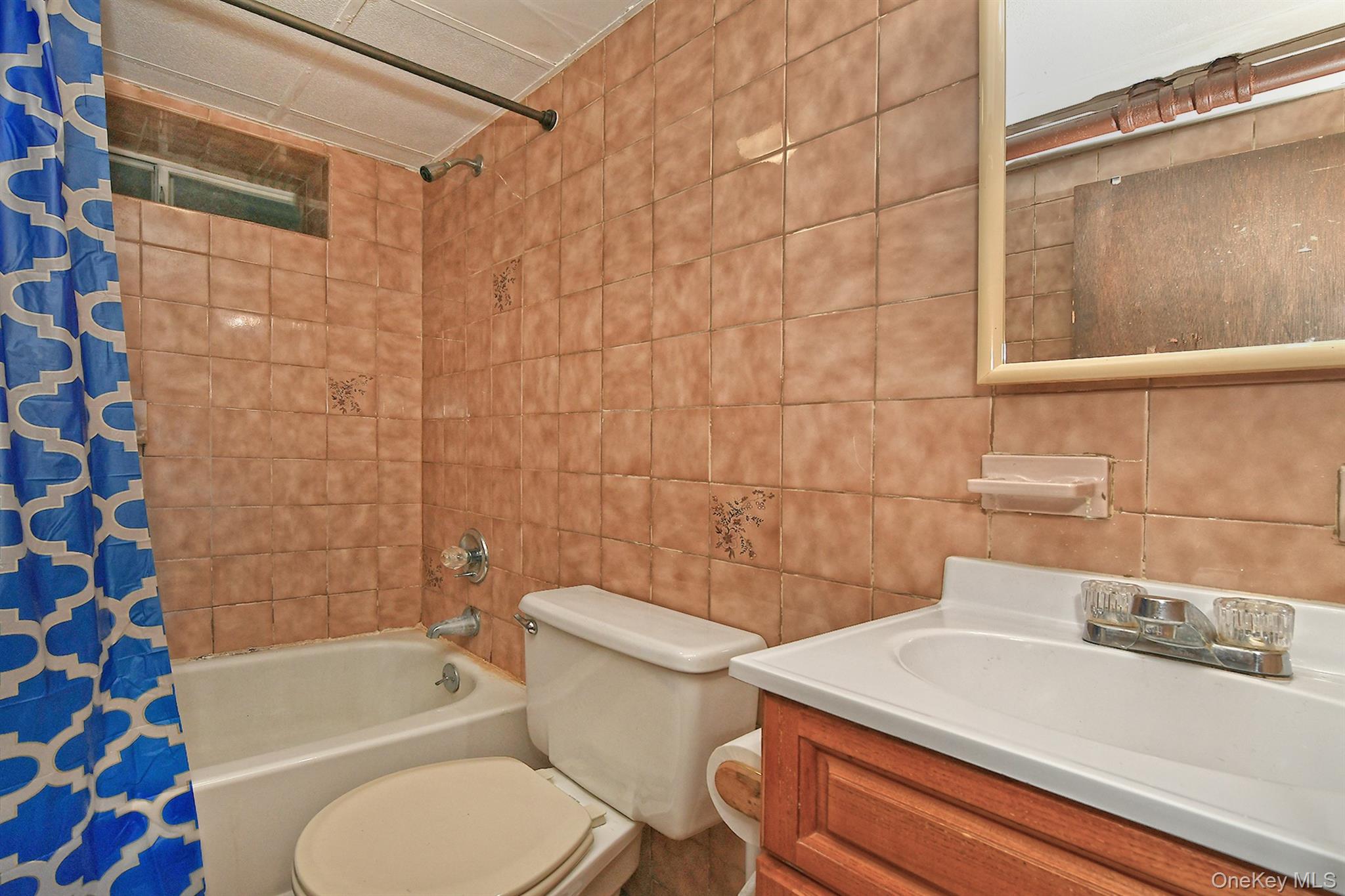 63-05 138th Street Queens, NY 11367 - Photo 17 of 22 Full bathroom with shower / bath combo, vanity, and tile walls