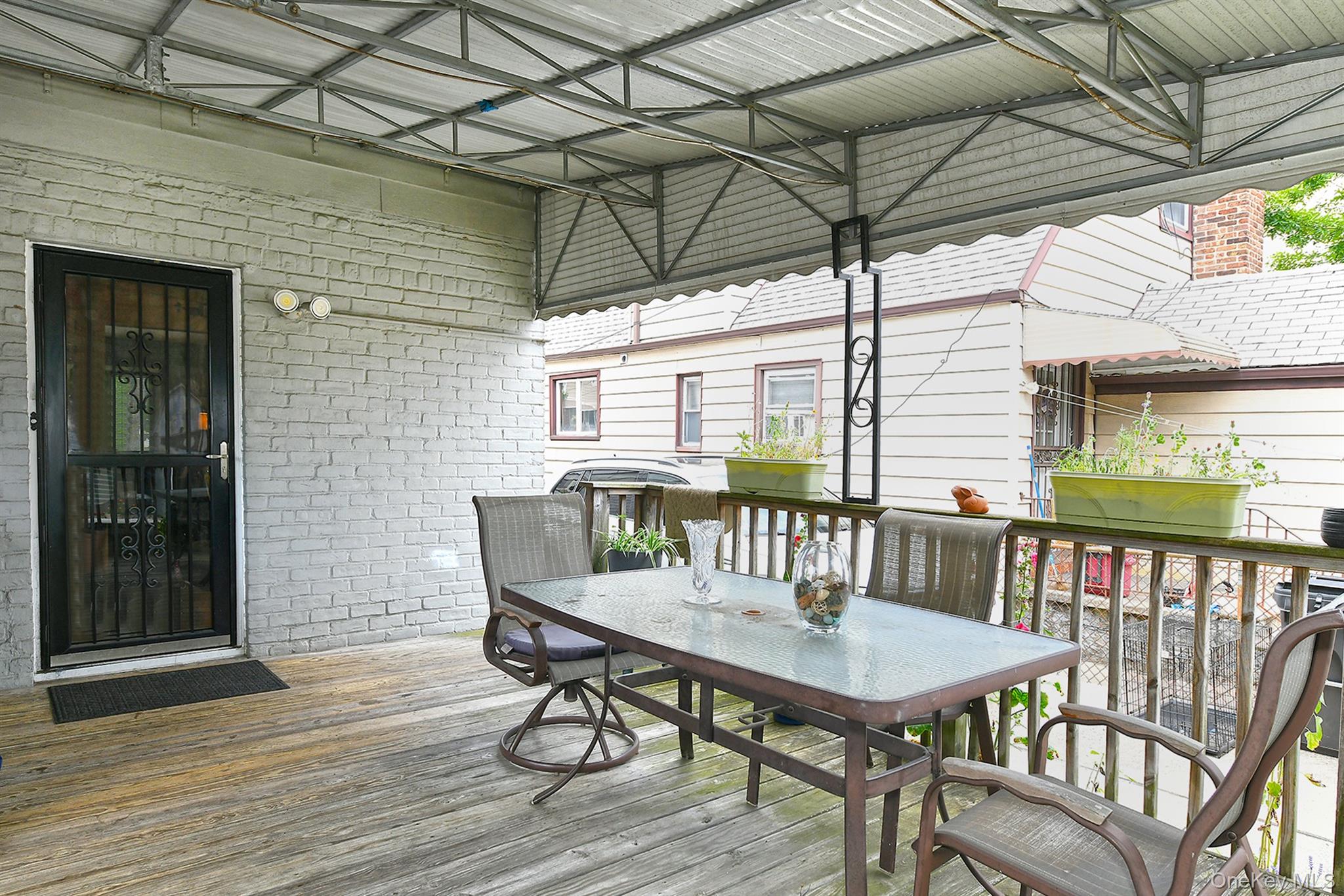 63-05 138th Street Queens, NY 11367 - Photo 19 of 22 Wooden terrace featuring outdoor dining space
