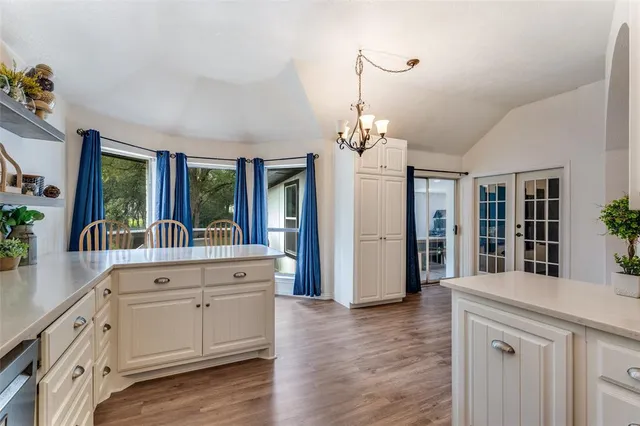 a large white kitchen with a large window