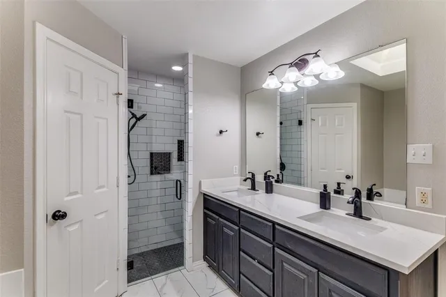 a bathroom with a sink double vanity and shower