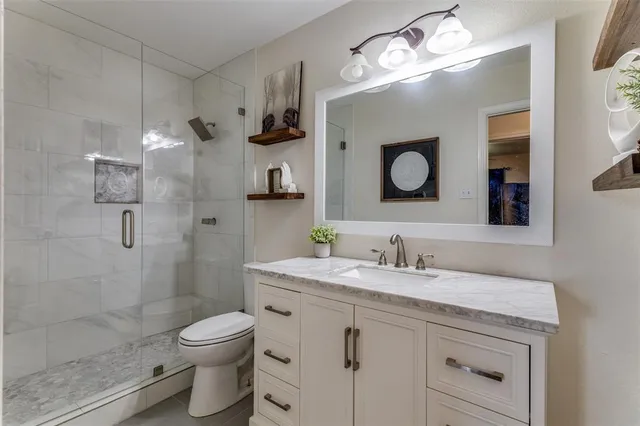 a bathroom with a toilet sink and shower