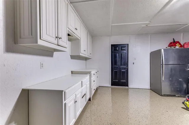 a kitchen with cabinets and stainless steel appliances