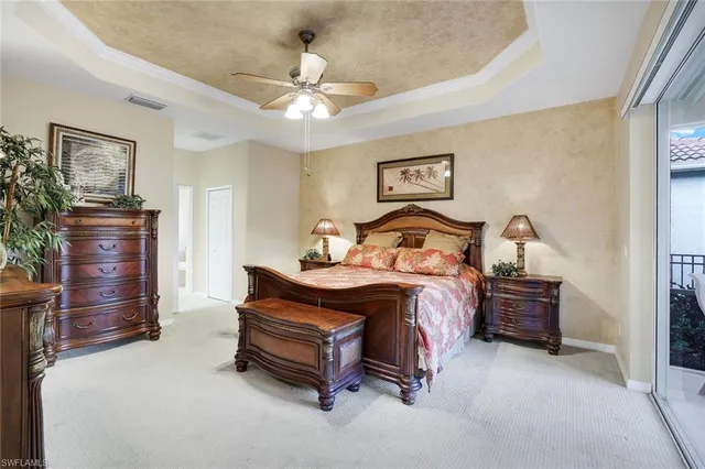 a bedroom with a bed and painting on the wall