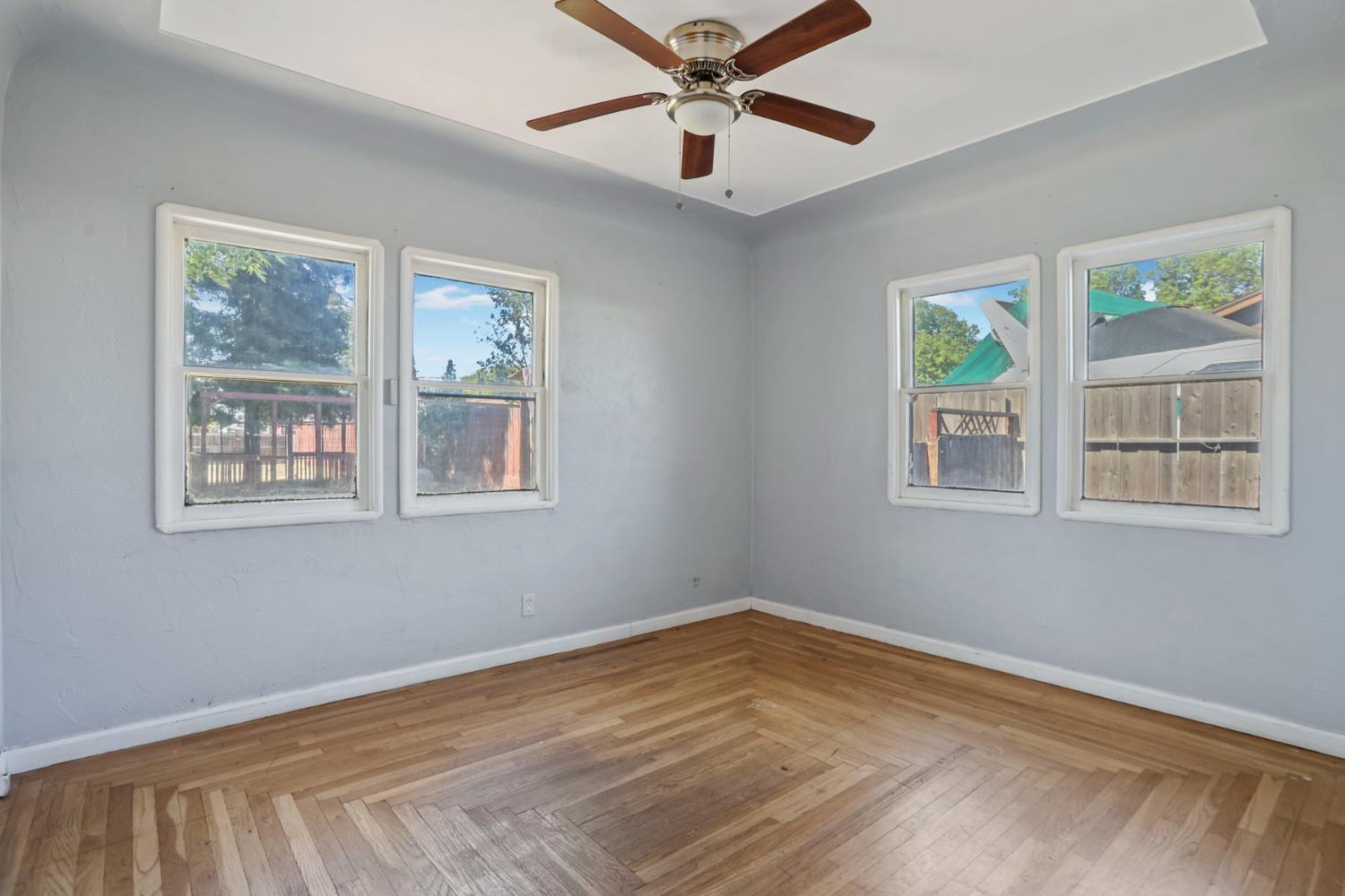 916 Elm Avenue Modesto, CA 95351 - Photo 25 of 52 26. Second bedroom / flexible room Another light-filled room with hardwood floors, ready to serve as a bedroom, office, creative space, or whatever life needs next.