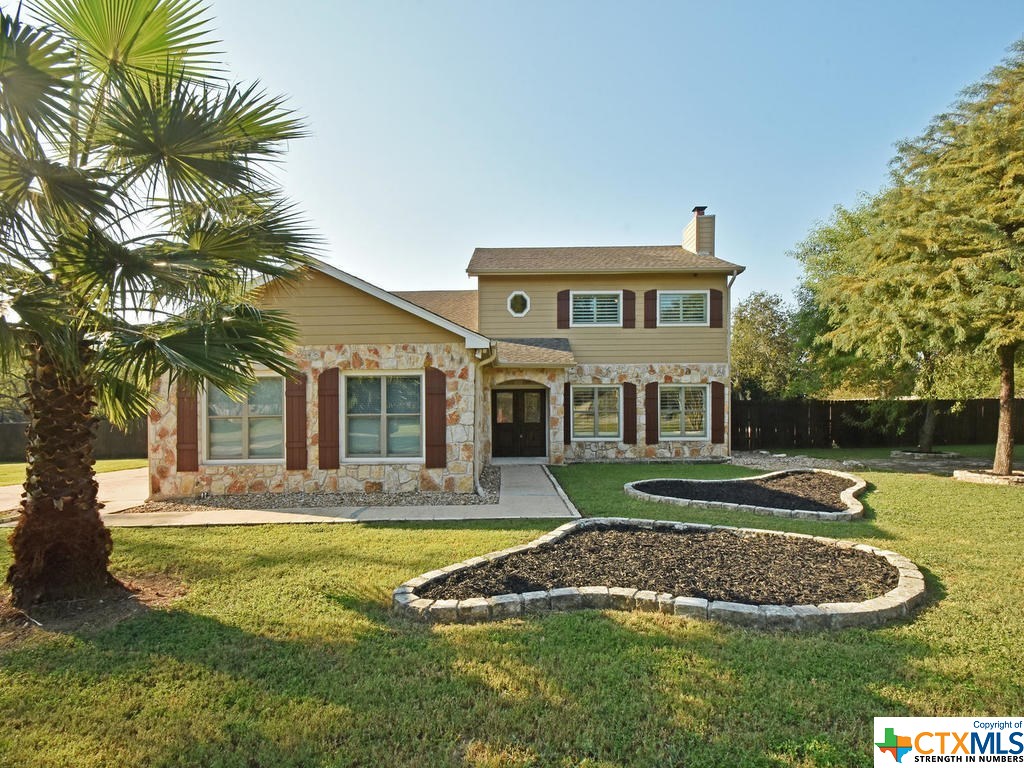 311 Dunlin Drive Buda, TX 78610 - Photo 1 of 1 a front view of a house with garden
