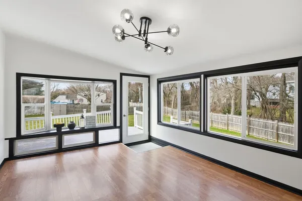 a view of a room with wooden floor and windows