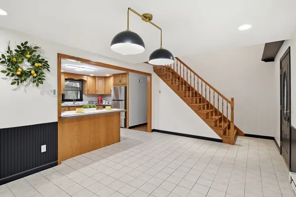 a kitchen with cabinets and wooden floor