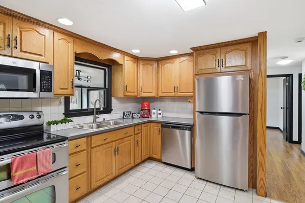 a kitchen with a sink window and cabinets