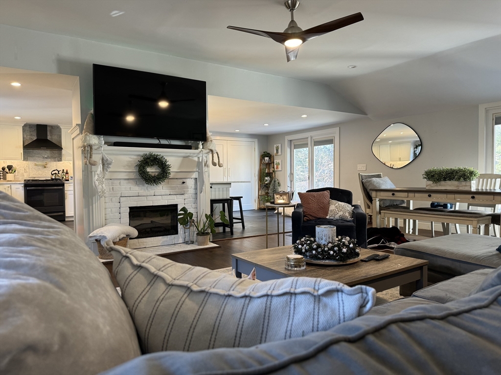 173 Guildford Road Barnstable, MA 02632 - Photo 15 of 26 a living room with fireplace furniture and a flat screen tv