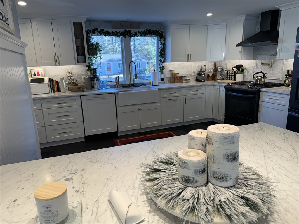 173 Guildford Road Barnstable, MA 02632 - Photo 3 of 26 a kitchen with a sink and wooden cabinets