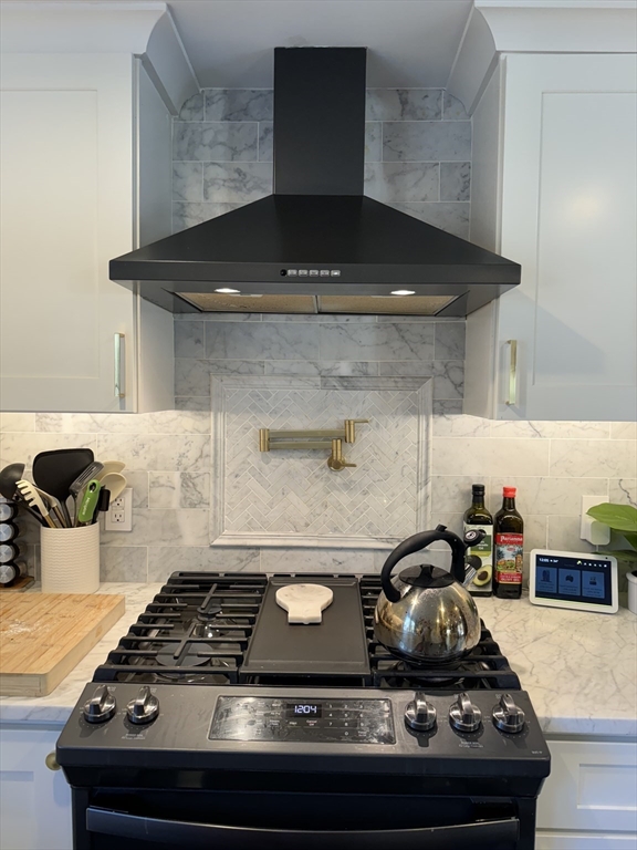 173 Guildford Road Barnstable, MA 02632 - Photo 7 of 26 a kitchen with a stove and cabinets