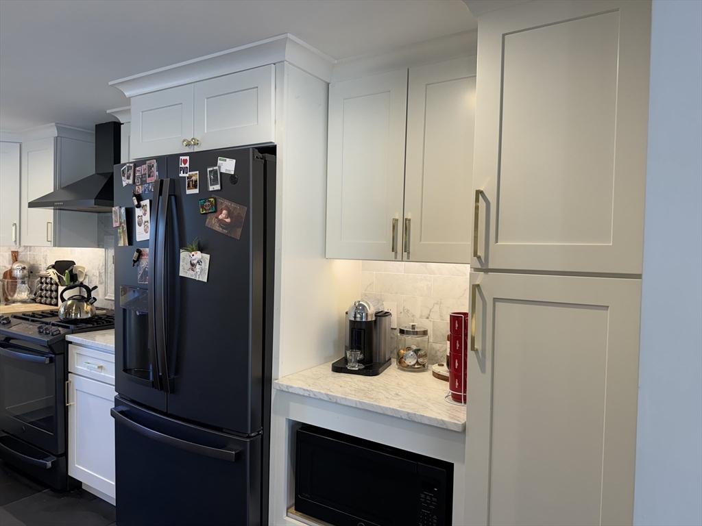 173 Guildford Road Barnstable, MA 02632 - Photo 9 of 26 a kitchen with stainless steel appliances a refrigerator and cabinets