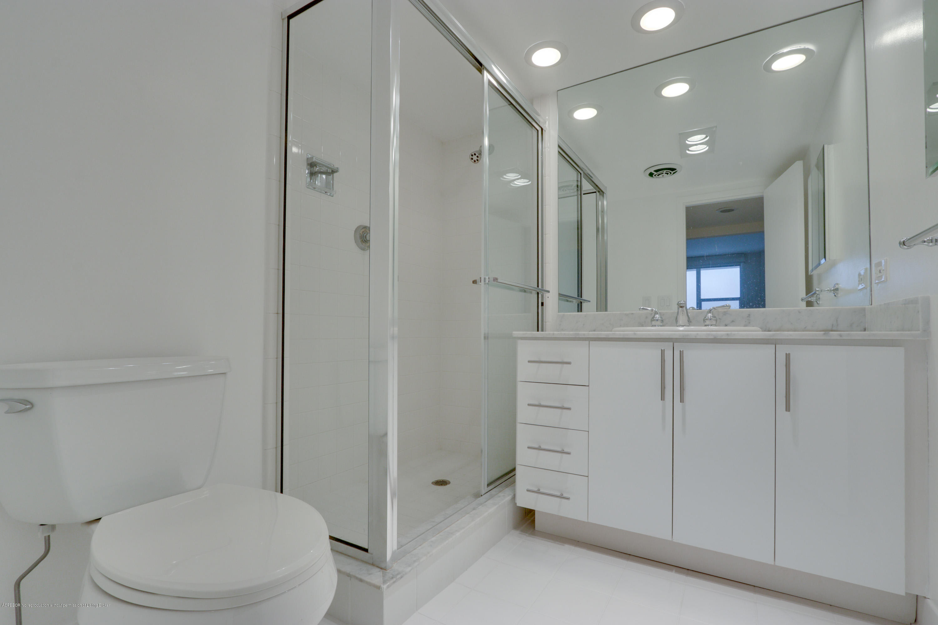 333 Sunset Avenue, Unit 308 Palm Beach, FL 33480 - Photo 21 of 29 a bathroom with a toilet a sink and mirror