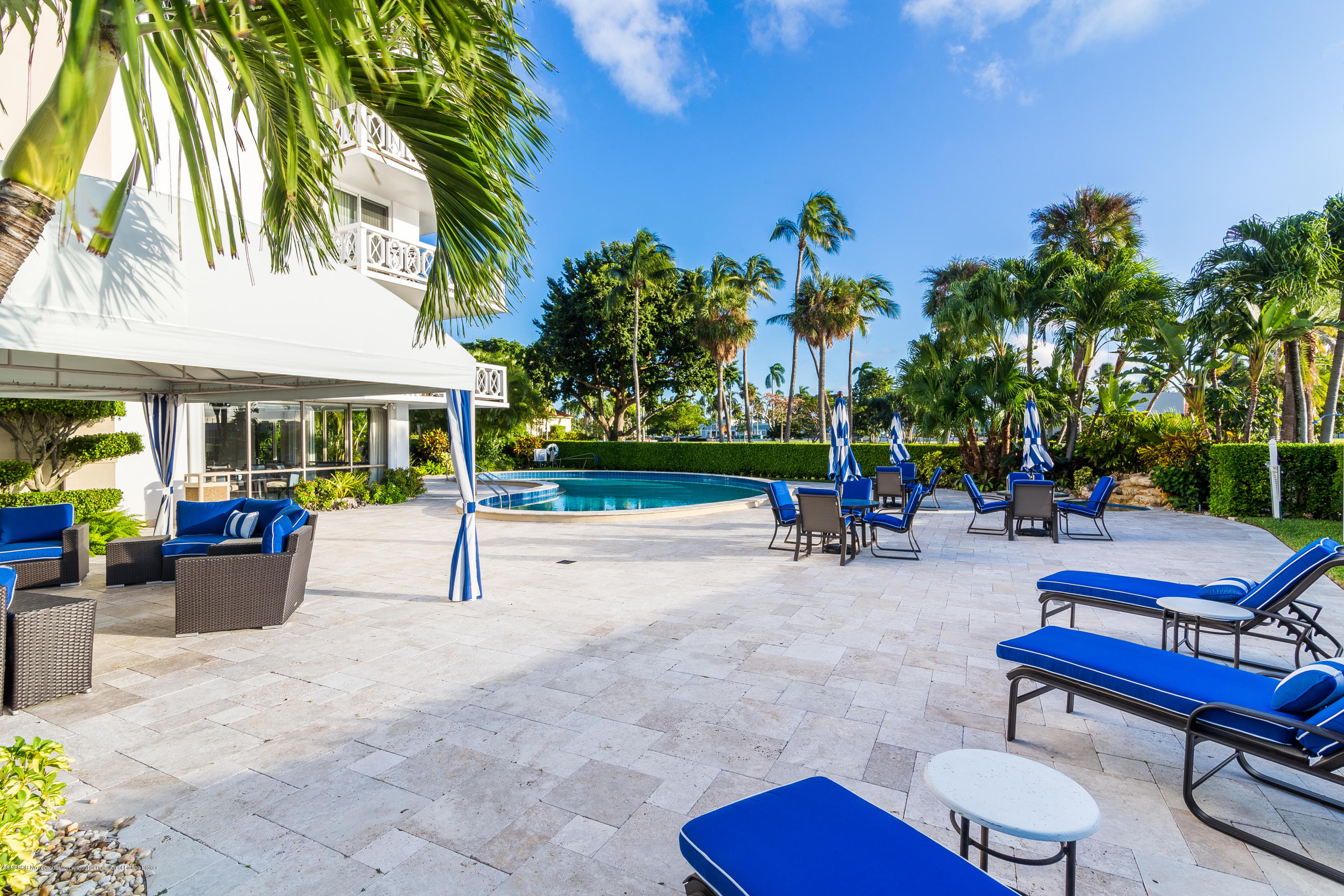 333 Sunset Avenue, Unit 308 Palm Beach, FL 33480 - Photo 25 of 29 a view of a patio with a table and chairs under an umbrella