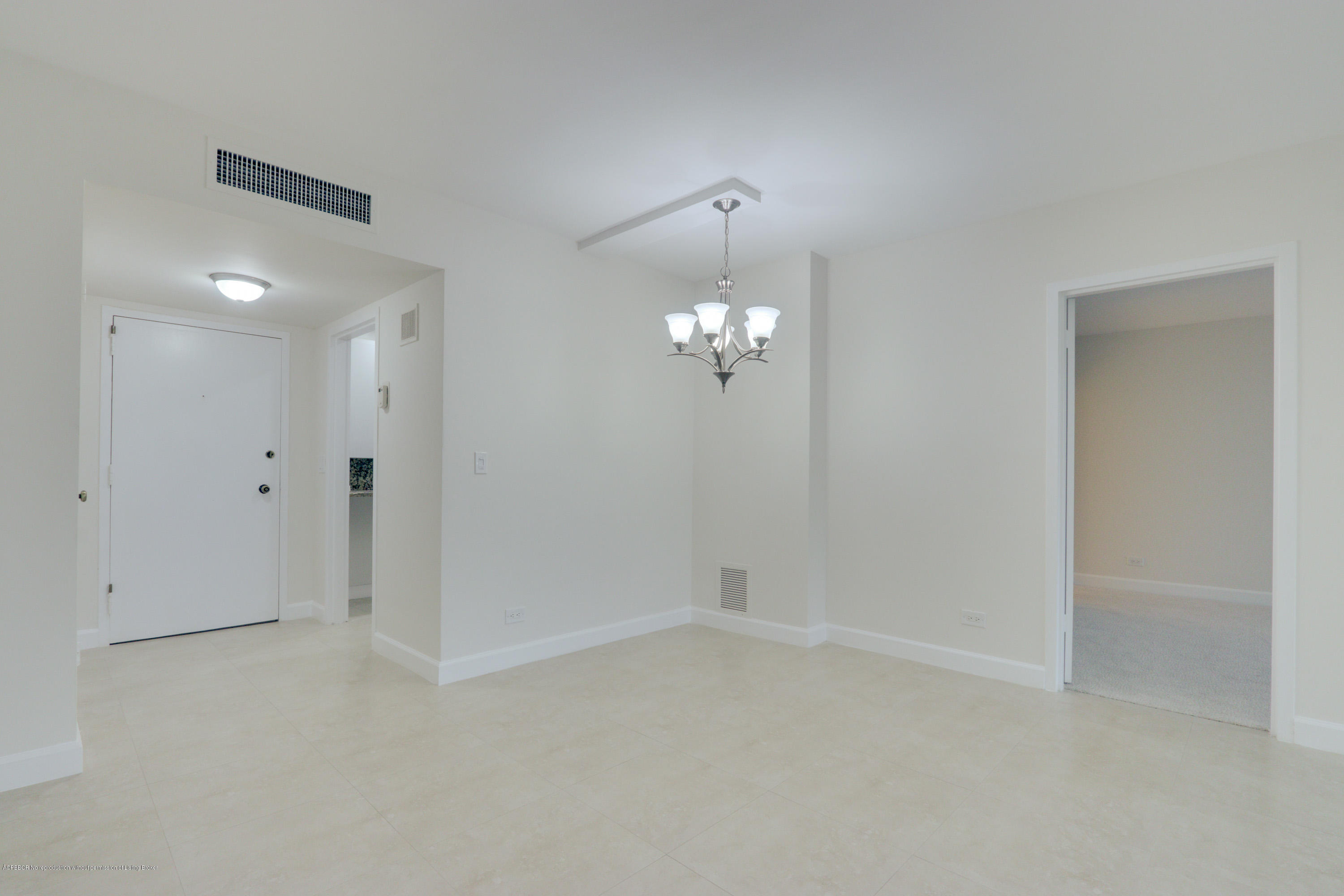 333 Sunset Avenue, Unit 308 Palm Beach, FL 33480 - Photo 8 of 29 an empty room with chandelier fan