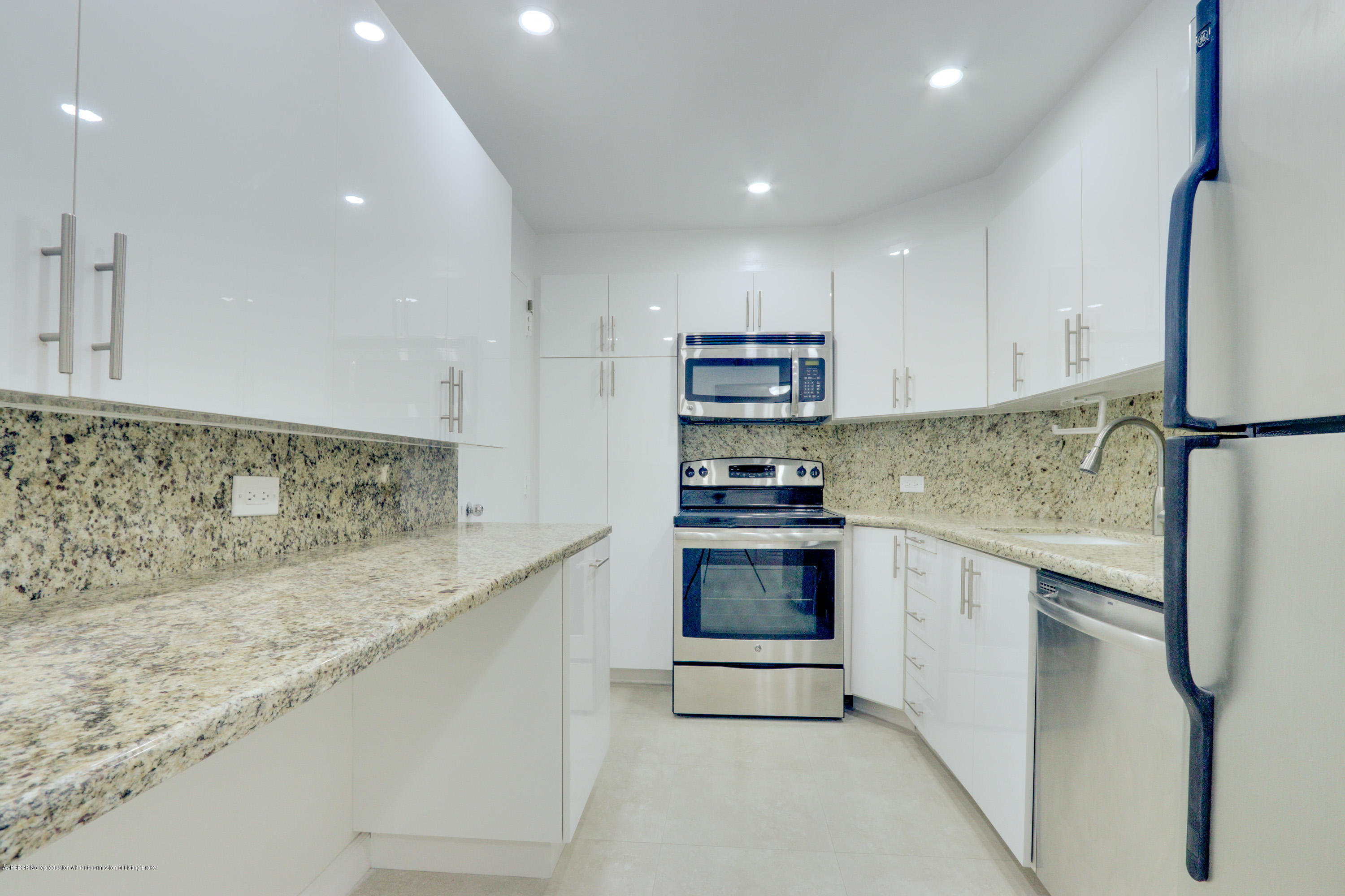 333 Sunset Avenue, Unit 308 Palm Beach, FL 33480 - Photo 9 of 29 a kitchen with kitchen island granite countertop a sink appliances and cabinets