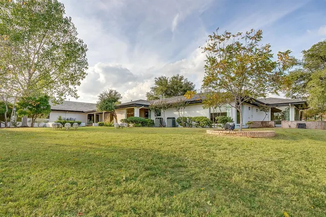 a house view with swimming pool in front of it